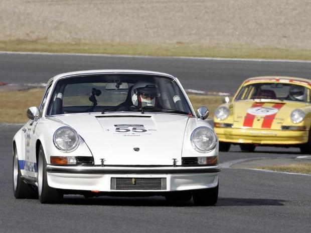 MINE, JAPAN: Japanese driver Junichi Yamano drives his 1973 Porsche 911 Carrera RS (L) leading a 1971 Porsche 911T (R) during the second round class 3 and 4 race of the Le Mans Classic Japan 2005 at the Mine circuit in Mine, Yamaguchi prefecture, 30 October 2005. Yamano won the class 4 category. AFP PHOTO / TOSHIFUMI KITAMURA (Photo credit should read TOSHIFUMI KITAMURA/AFP/Getty Images) 