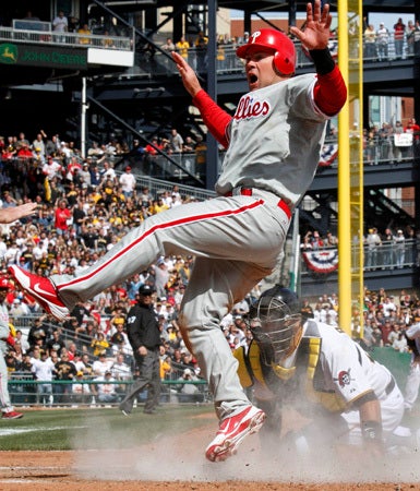Ty Wigginton, left, scores ahead of the tag by Pittsburgh Pirates catcher Rod Barajas  
