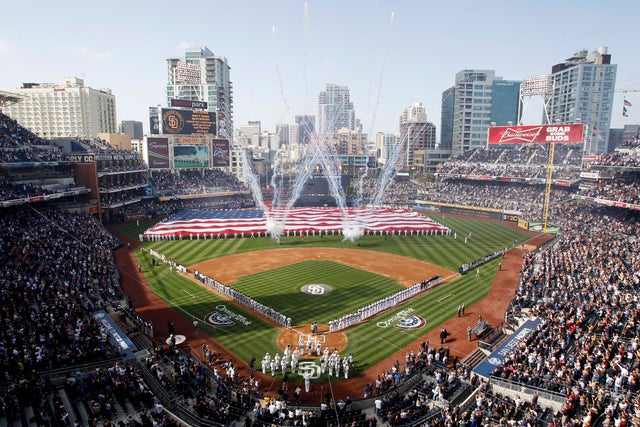 Players and spectators stand during opening day ceremonies 