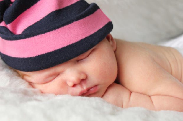 Newborn baby wearing hat 