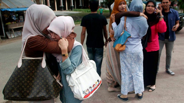 Acehnese women comfort each other after a strong earthquake was felt in Banda Aceh 