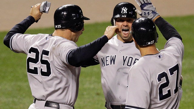 Nick Swisher meets Mark Teixeira and Raul Ibanez at home plate after a home run 