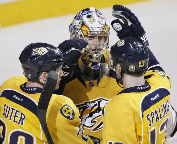 Pekka Rinne is congratulated by Ryan Suter and Nick Spaling  