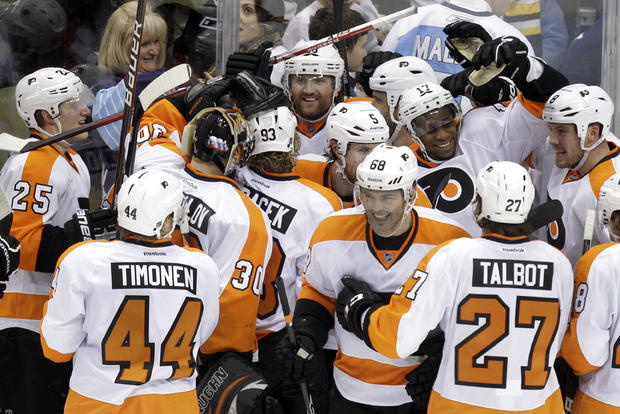 Flyers' Jakub Voracek (93) is surrounded by teammates as they celebrate his game-winning goal 