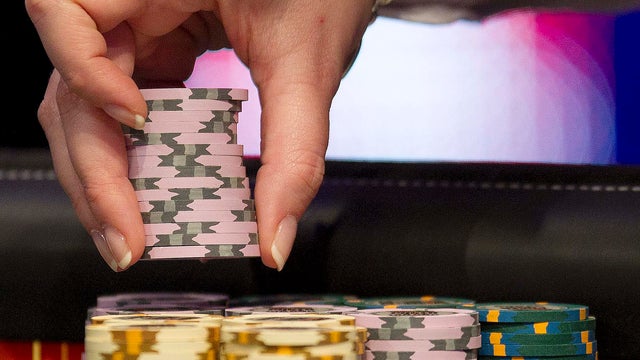 A dealer arranges chips in preparation for play at the final table of the World Series of Poker in Las Vegas on Nov. 6, 2011. 