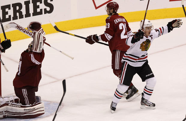 Jonathan Toews, right, celebrates a late game-tying goal by teammate Patrick Sharp  