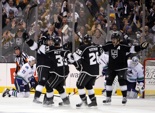 Kings right wing Dustin Brown, second from left, celebrates scoring a goal  