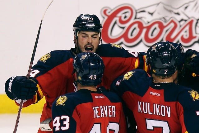 Florida Panthers' Erik Gudbranson (44), Dmitry Kulikov (7) and Mike Weaver (43) celebrate after the third period  
