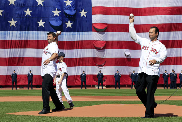Former Boston Red Sox players, catcher Jason Varitek, left, and pitcher Tim Wakefield, right, throw ceremonial first pitches 