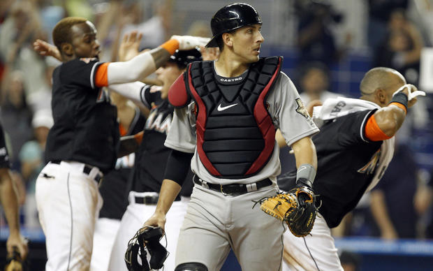 Jason Castro watches as the Miami Marlins celebrate their 11th inning 5-4 victory 