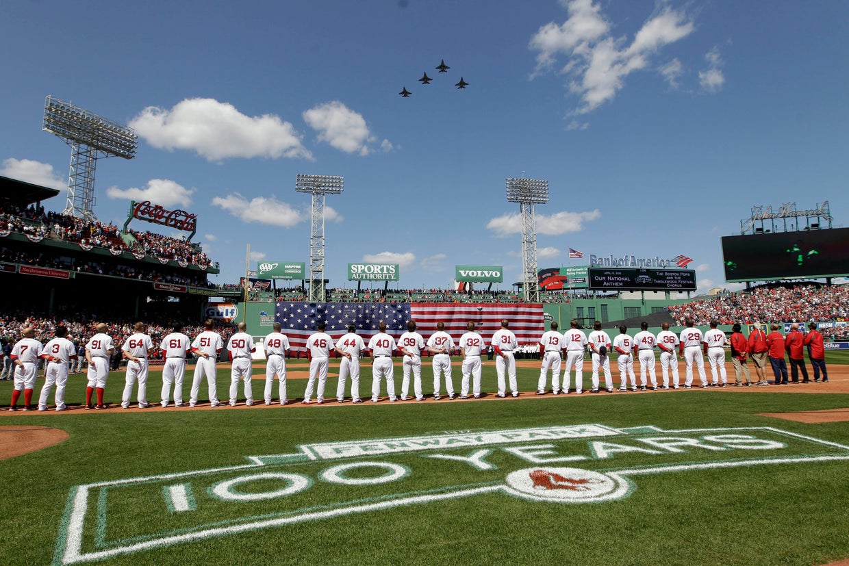 Boston Red Sox players line up for the national anthem as fighter jets from the Vermont National Guard fly over Fenway Park 