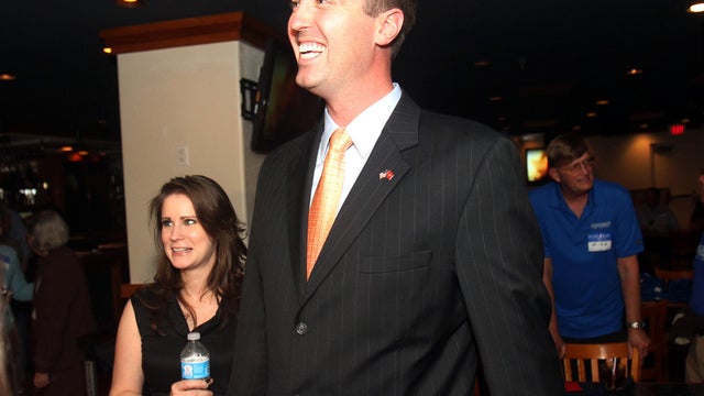Republican Jesse Kelly, center, smiles as he waits for special election primary results for southern Arizona's 8th Congressional District with his wife, Aubrey Kelly, at the Viscount Suite Hotel in Tucson, Ariz., April 17, 2012. 