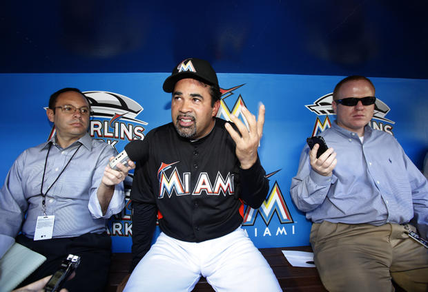 Ozzie Guillen talks to reporters before the Marlins' baseball game 