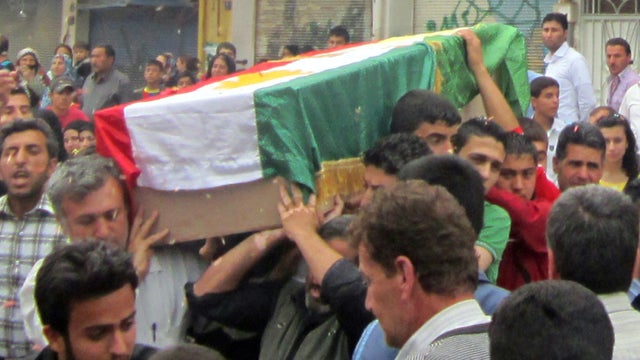 Syrian mourners carry the coffin of Mazloum Hussein Khalil, an alleged victim of recent violence in the northern, mostly Kurdish region of Qamishli, Syria, April 18, 2012. 