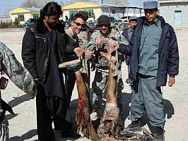Soldiers from the Army's 82nd Airborne Division pose with the mangled corpose of a suicide bomber in Afghanistan's Zabol province. The image was first published in the LA Times, which received it from an unnamed soldier in the division.In this image provided to the LA Times by a soldier in the division. 