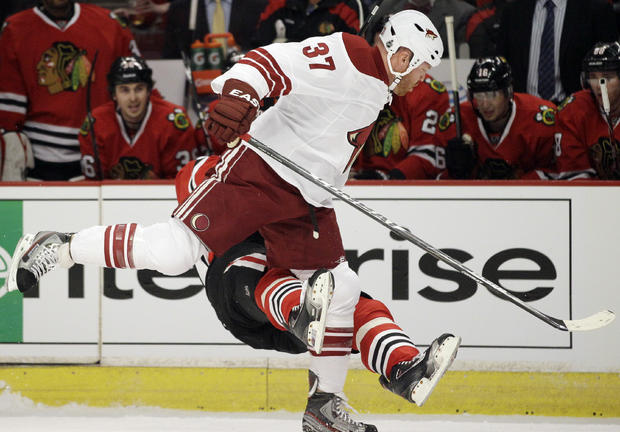 Marian Hossa falls down after taking a hit from Raffi Torres 