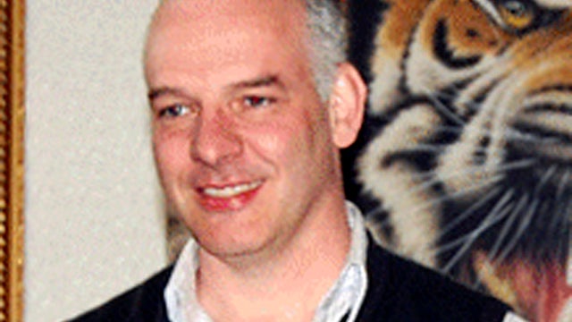 British businessman Neil Heywood poses for photos at an art gallery in Beijing April 12, 2011. 