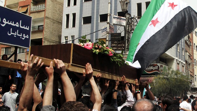 Syrian mourners carry the body of Rama Saada, 9, who was shot by Syrian forces in Douma, Syria, April 18, 2012. 