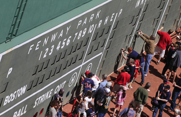 People view the scoreboard section of the Green Monster left field 