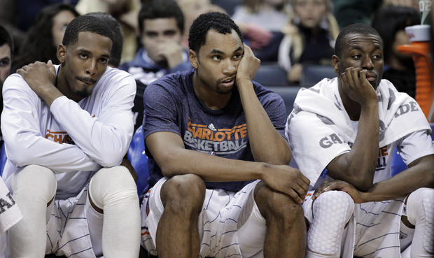 Charlotte Bobcats players, from left, Derrick Brown, Gerald Henderson and Kemba Walker watch from the bench 