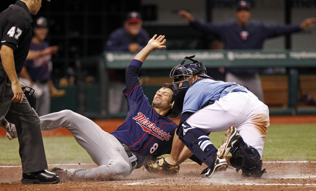 Jamey Carroll slides in safely ahead of a tag 