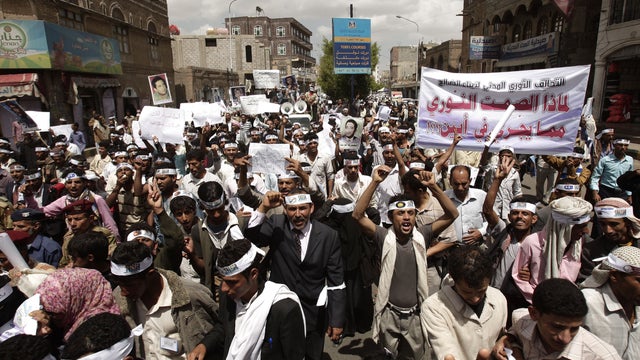 Yemeni members of the Peaceful Revolution Salvation Front chant slogans during a demonstration demanding independence of the judicial system from government control, in Sanaa, Yemen, Monday, April 23, 2012. Arabic on the banner reads, "why the revolutiona 