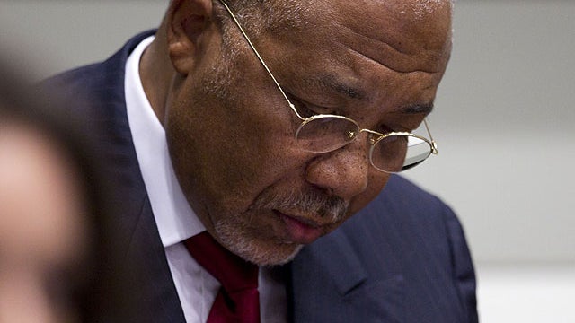 Former Liberian President Charles Taylor looks down as he waits for the start of a hearing to deliver verdict in the court room of the Special Court for Sierra Leone in Leidschendam, near The Hague, Netherlands, April 26, 2012.  