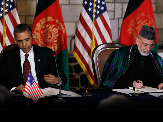 President Barack Obama and Afghan President Hamid Karzai sign a strategic partnership agreement at the presidential palace in Kabul, Afghanistan, Wednesday, May 2, 2012. 