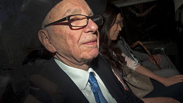News Corp Chief Rupert Murdoch, left, his wife Wendi and son Lachlan are driven away from the High Court in central London on April 26, 2012 after Murdoch's second and final day of giving evidence at the Leveson Inquiry.  