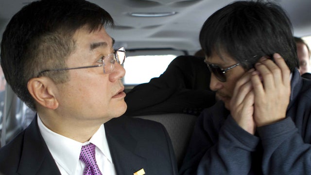 U.S. Ambassador to China Gary Locke, left, and Chinese activist Chen Guangcheng ride from the American Embassy in Beijing to a hospital May 2, 2012. 