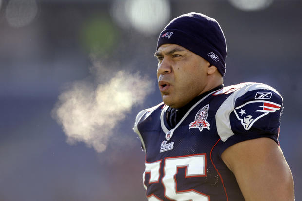 Junior Seau warms up on the field before an NFL wild-card playoff football game 