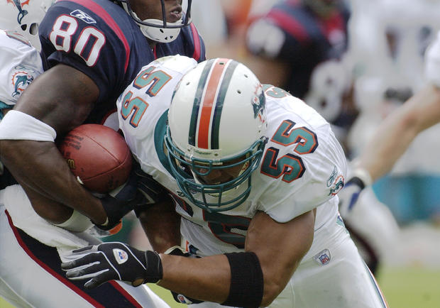 Junior Seau tackles for the ball 