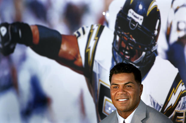 Junior Seau smiles during a news conference announcing his retirement 