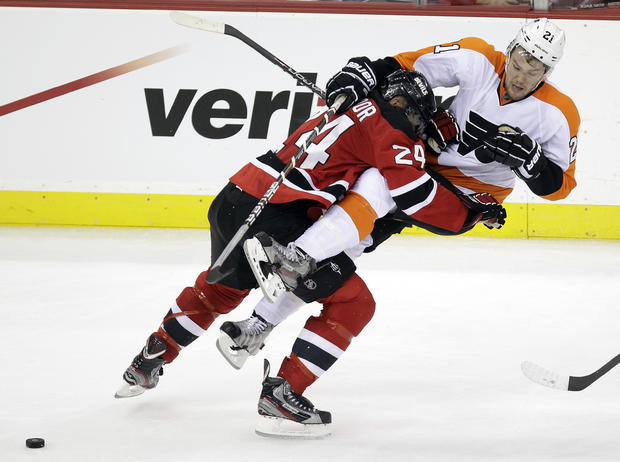 Bryce Salvador checks Philadelphia Flyers' James van Riemsdyk 