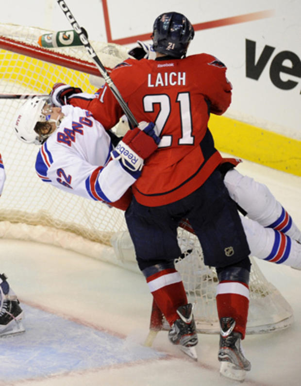 Brooks Laich and Carl Hagelin crash into the net 