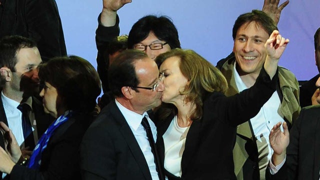 French president-elect Francois Hollande, left, embraces his companion Valerie Trierweiler after greeting crowds gathered to celebrate his election victory in Bastille Square in Paris, France handed the presidency Sunday to leftist Hollande, a champion of 