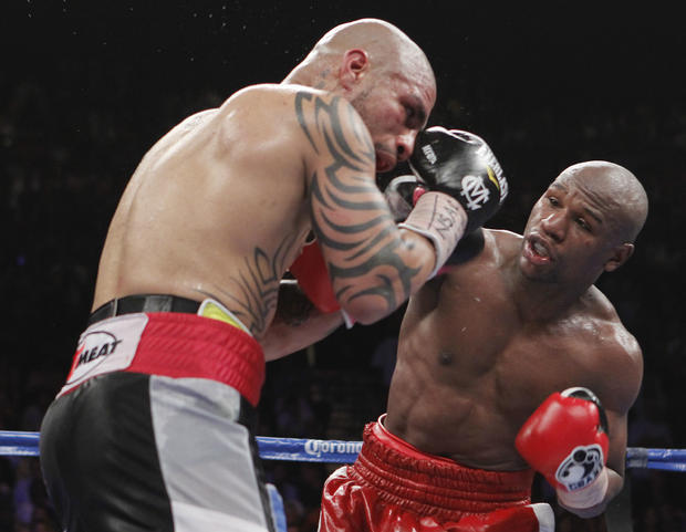 Floyd Mayweather Jr. punches at Miguel Cotto Jr. 