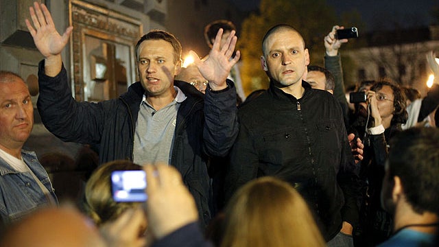 Alexei Navalny, a prominent anti-corruption whistle blower and blogger, left, and opposition leader Sergei Udaltsov speak to protesters gathered near the presidential administrations building in downtown Moscow early Tuesday, May 8, 2012, a day after Puti 