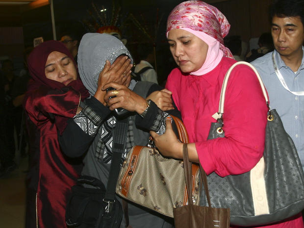 A relative weeps after inspecting the list of passengers reportedly on board a missing Russian airplane at Halim Perdanakusuma Airport in Jakarta, Indonesia, May 9, 2012. 