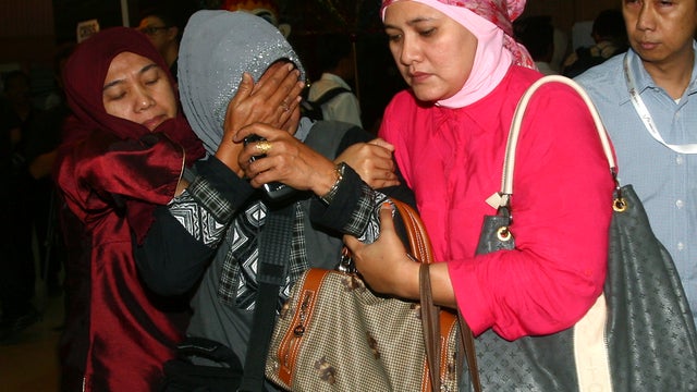 A relative weeps after inspecting the list of passengers reportedly on board a missing Russian airplane at Halim Perdanakusuma Airport in Jakarta, Indonesia, May 9, 2012. 