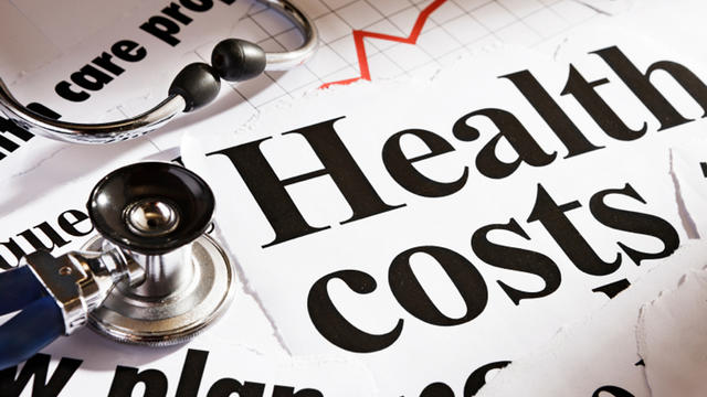 Health cost headlines, stethoscope and rising graph 
