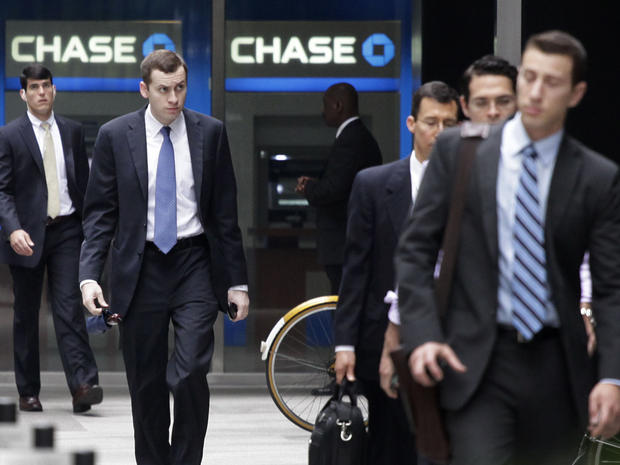 People arrive at JPMorgan Chase headquarters in New York Monday, May 14, 2012. JPMorgan, the largest bank in the United States, is seeking to minimize the damage caused by a $2 billion trading loss, disclosed Thursday by CEO Jamie Dimon. 