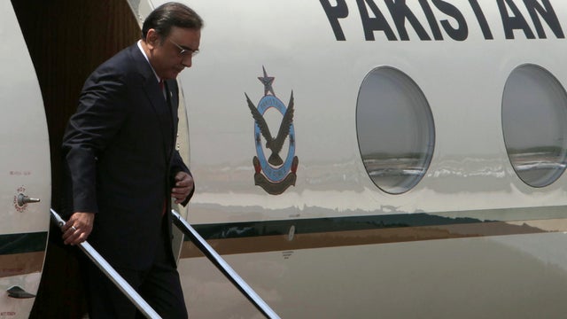 Pakistani President Asif Ali Zardari disembarks from an aircraft after arriving in New Delhi April 8, 2012. 