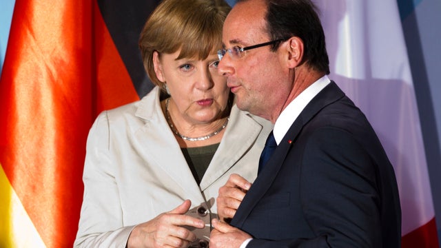 German Chancellor Angela Merkel, left, talks to new French President Francois Hollande after a news conference at the chancellery in Berlin, Tuesday, May 15, 2012. 