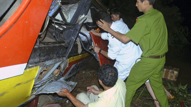 Rescuers work to search for victims of a bus accident 