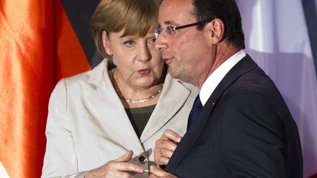 German Chancellor Angela Merkel, left, talks to new French President Francois Hollande 