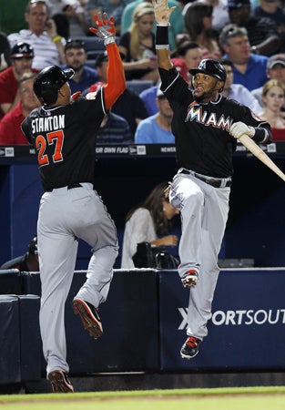 Giancarlo Stanton celebrates with Emilio Bonifacio 