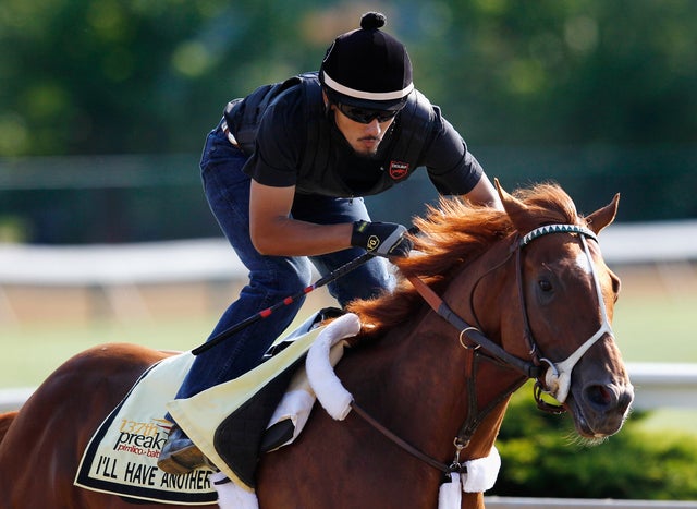 Exercise rider Jonny Garcia takes I'll Have Another over the track in preparatio 