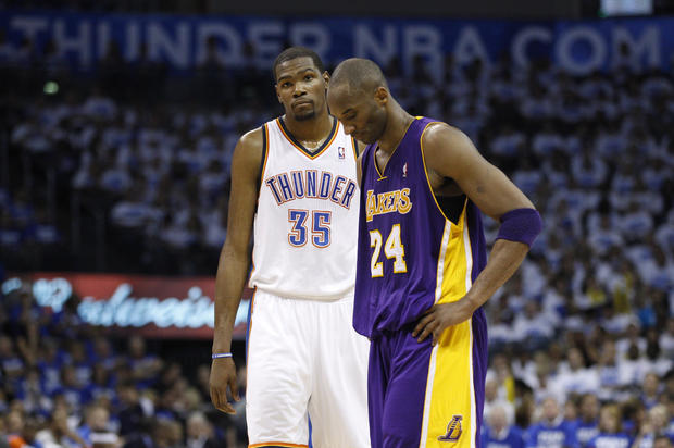 Kevin Durant and Kobe Bryant  stand during a free throw  