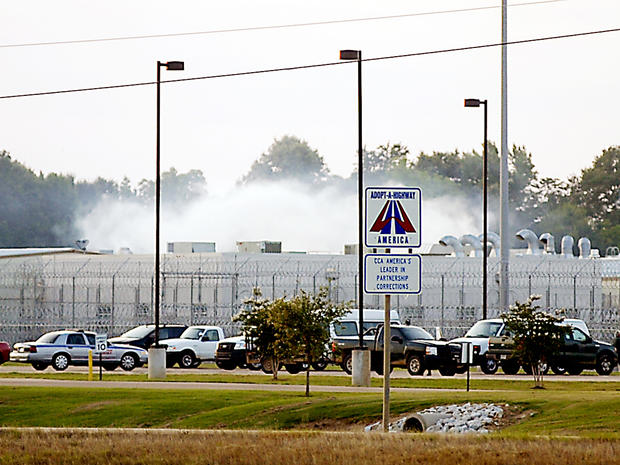 Smoke rises above the Adams County Correctional Center in Natchez, Miss., May 20, 2012, during an inmate disturbance at the prison. 